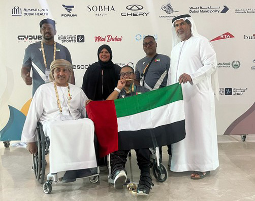 Emirati-athlete-Humaid-Alblooshi-poses-for-an-award-ceremony-photo-with-his-family-and-coach